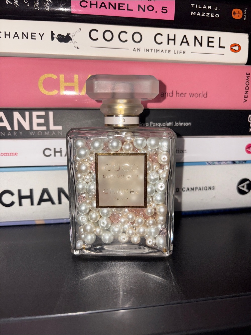 CHANEL pearl-filled glass bottle with gold label